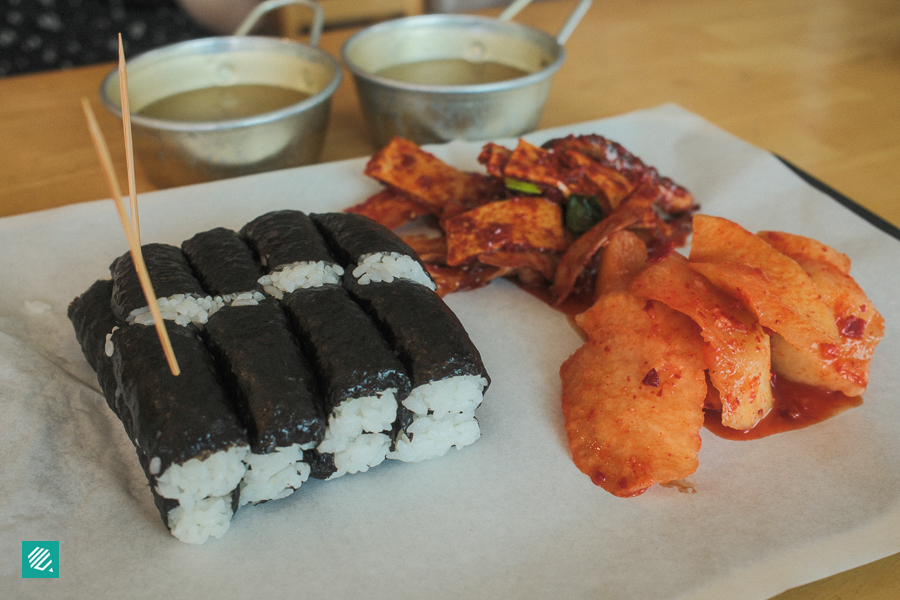 Korean plain gimbap with side dishes like kimchi