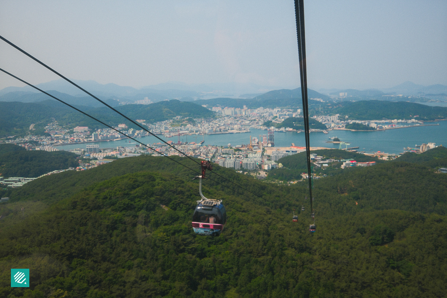 Cable car over lush green landscape